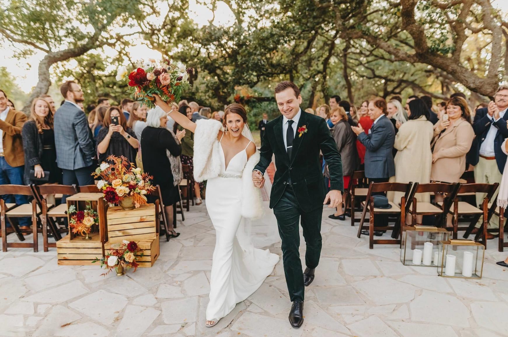 Addison Grove a just married man and woman walking down a path with a crowd of people