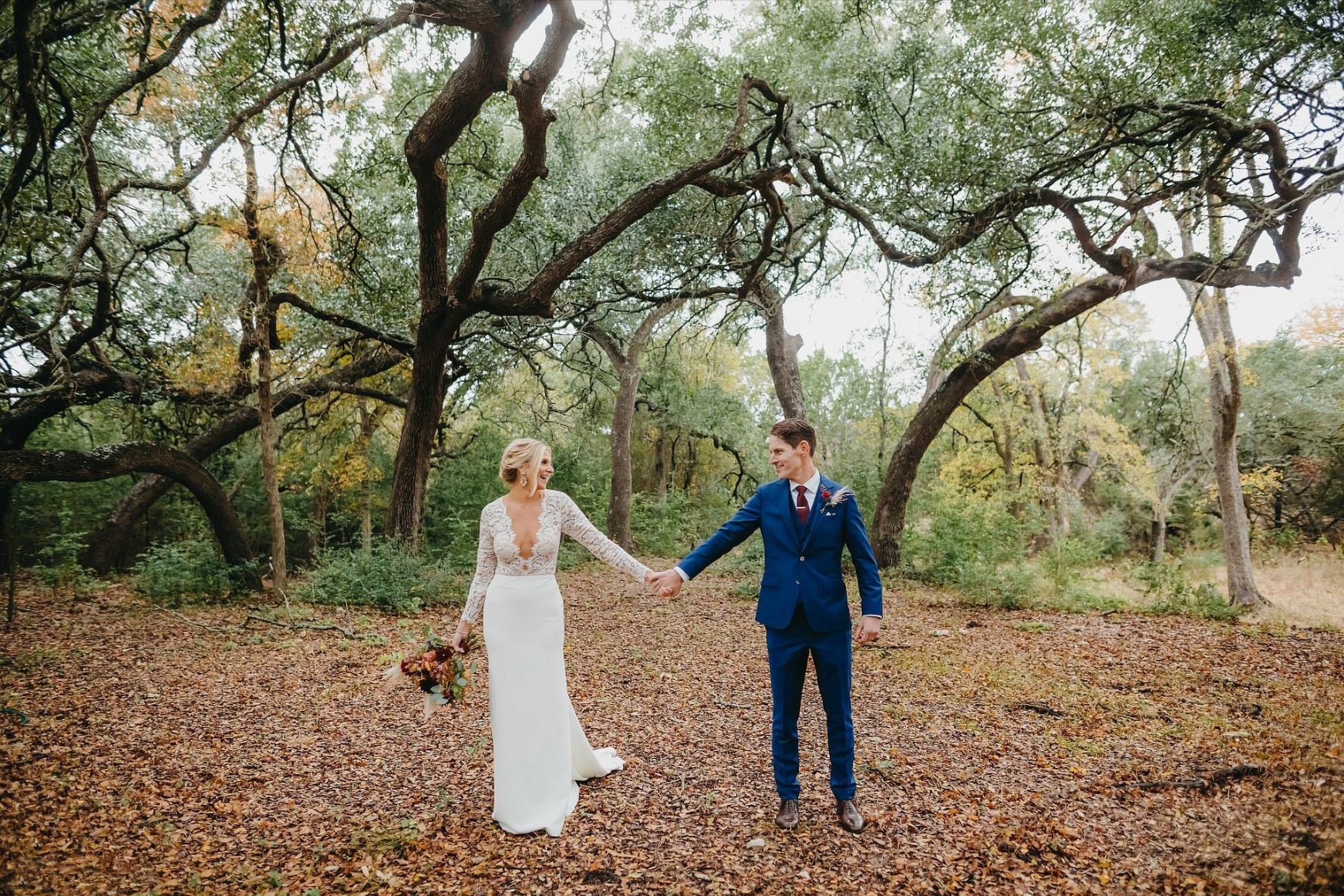 Addison Grove a man and woman holding hands and walking in the woods